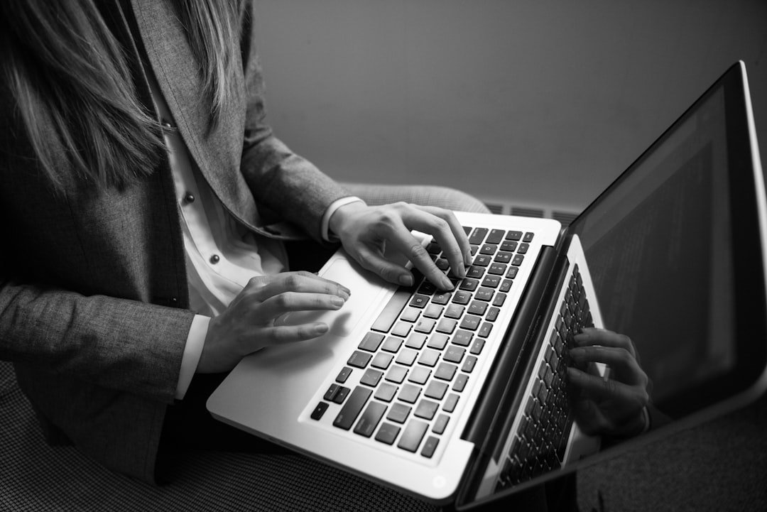 grayscale-photography-of-woman-typing-on-a-laptop-ekethvo9vfm
